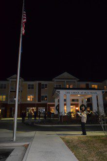 a man is standing in front of a building at night